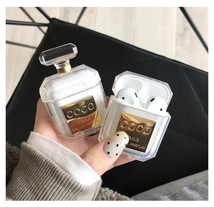 A bottle of perfume sitting next to a laptop photo – Free Airpods